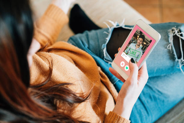 Sex Hookups in 2025 - A person swiping on a dating app while relaxing at home